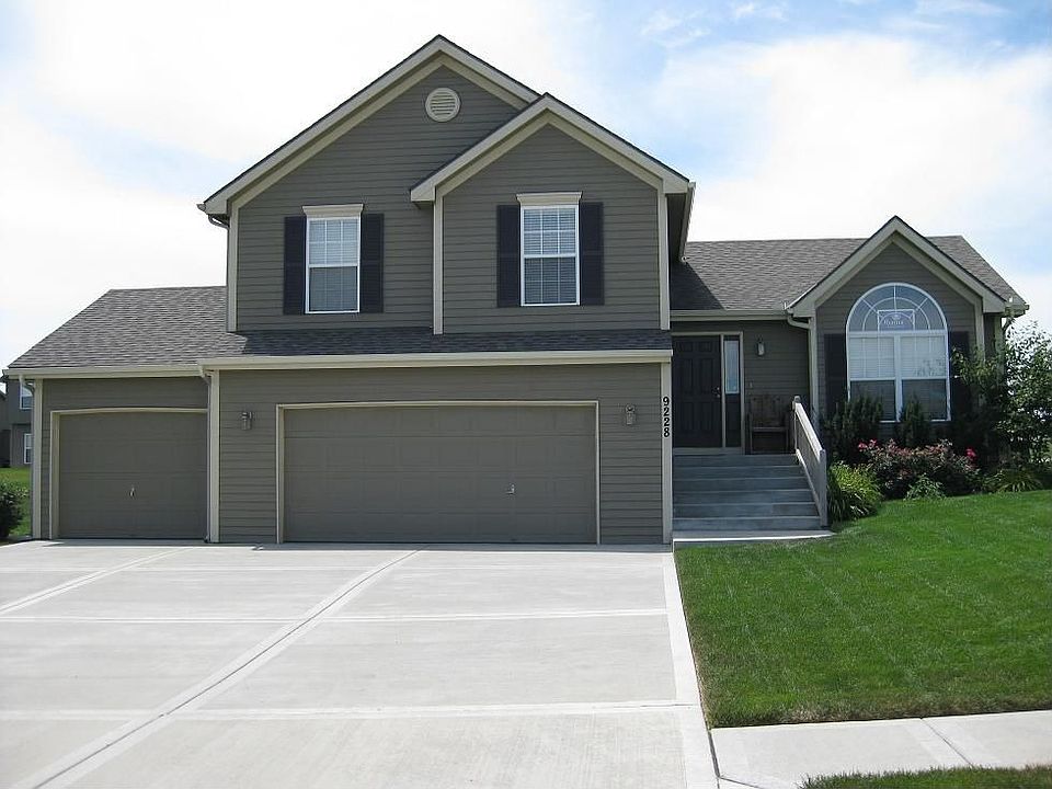 Deep 3-car garage with workbench has ample room for another car or some toys.