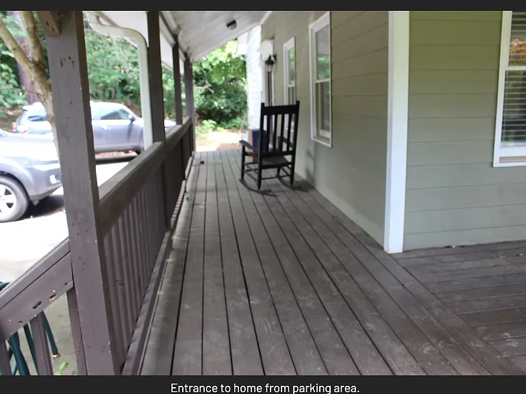Wrap around porch; parking and garage to left.