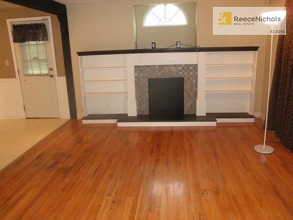 Former fireplace with bookshelves and place on mantle for a larg