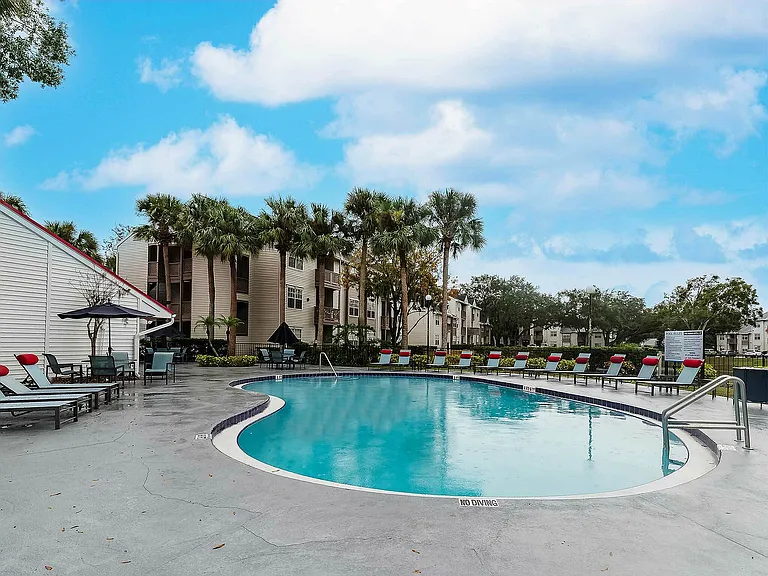 Experience serene poolside living with lush tropical scenery.