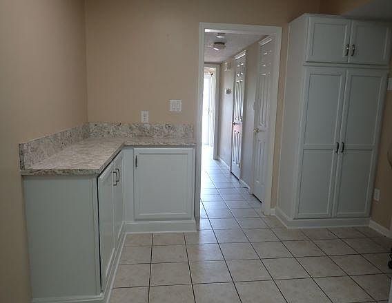 Kitchen with cabinets and hallway