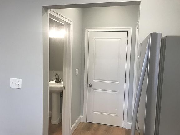 Garage entrance with view of half bath