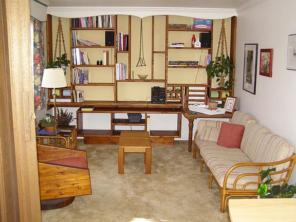 living room with floor to ceiling built in shelves