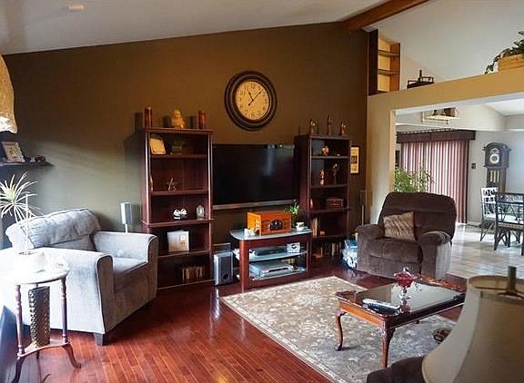 View from the entry foyer. Real wood floors & note the vault ceiling & plant shelf.