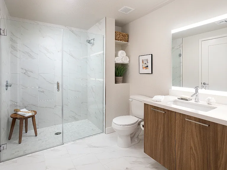 Spa-like bathrooms with rain shower head, custom shelves and stunning granite surrounds