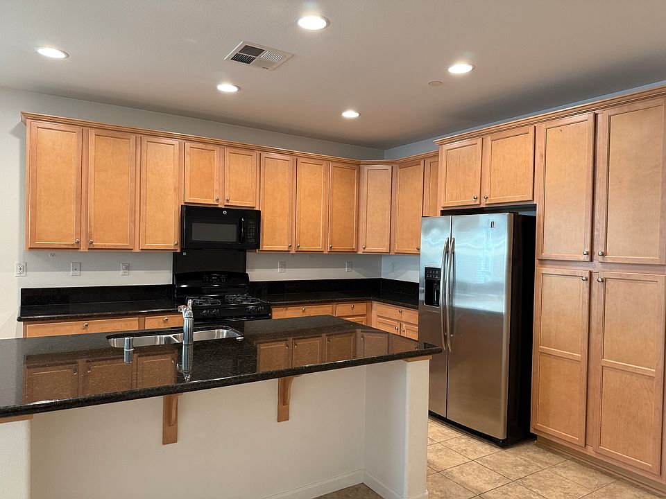 Kitchen with Fridge, Microwave, Range and Dishwasher.