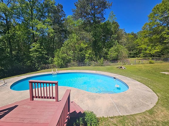 Deer, turkys, rabbits, and other wildlife call the back field home. The woods that back the property give privacy and ample fire wood to burn in the fire pit. Property line goes approximately 2 feet past the chain-link fence. Past that is private property