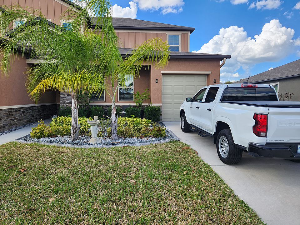 Front exterior of the Mother-in-Law Suite. The suite has its own private entry (front door to the left of the two front windows) plus a dedicated 1-car garage and driveway parking.