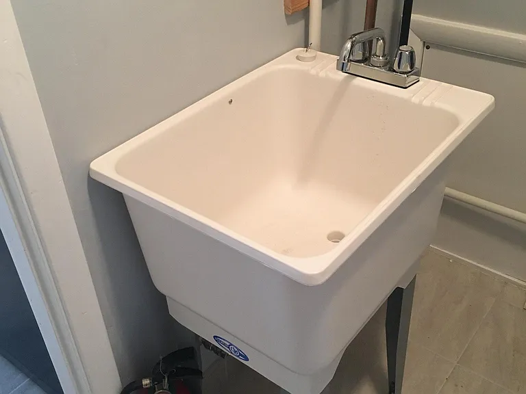 Laundry washtub, just inside side door and off kitchen.