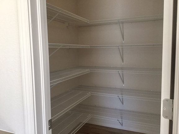 Spacious walk-in pantry with lots of shelving. (Photo of home under construction)