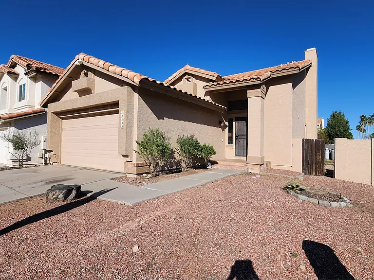 Beautiful home with great curb appeal, low-maintenance desert landscaping, and a spacious driveway. Located in a desirable neighborhood with a welcoming entrance and clean, well-kept exterior.