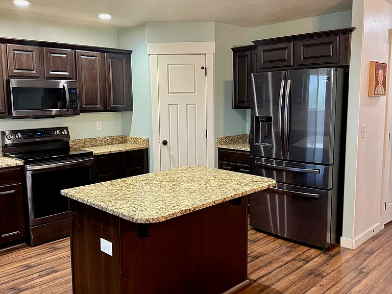 Large kitchen with pantry and additional storage under the stairs.