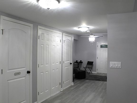 The hallway houses the laundry and utility closets.