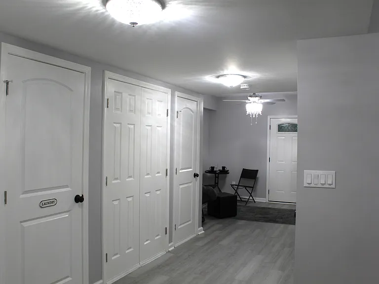 The hallway houses the laundry and utility closets.