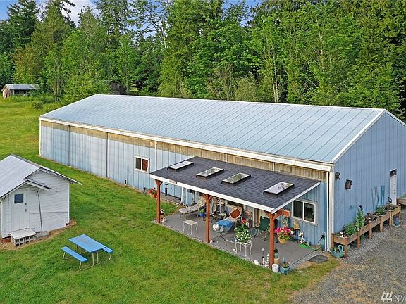 Spacious covered front porch to apartment in detached garage. Shed to the left.