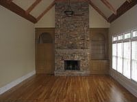Vaulted family room with stacked stone fireplace. 