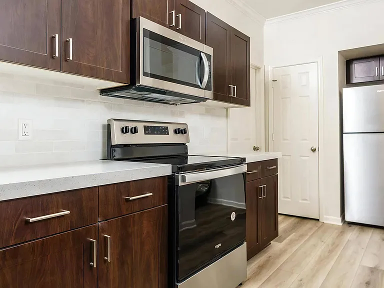 Quartz Countertops Highlight This Updated Kitchen with Stainless Steel Appliances