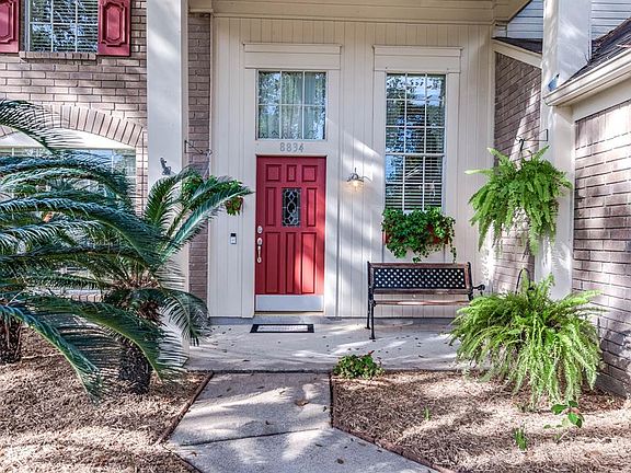 Approaching the front door you will see the beautiful brick elevation, lovely landscaping, covered front porch, and red front do
