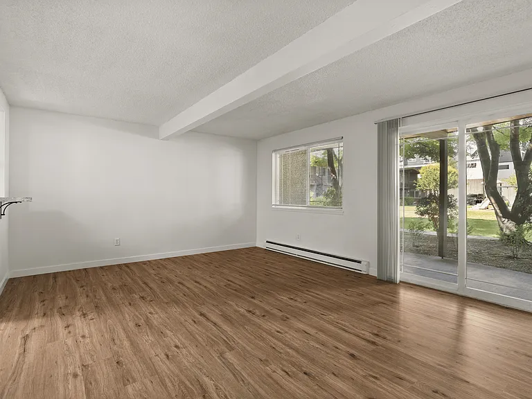 Open living space with modern flooring and access to your private patio. Open living space with modern flooring and access to your private patio.