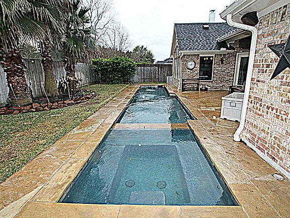 TAKE A MINI VACATION IN YOUR OWN BACKYARD FEATURING A HEATED POOL AND OVERSIZED SPA