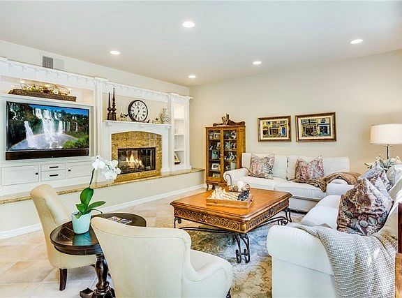 Generously sized family room with built-in entertainment center, and welcoming raised hearth firepla