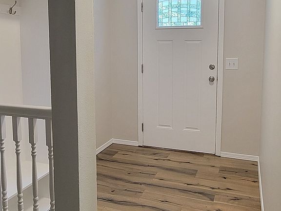 Front door, foyer, and coat rack on the left.