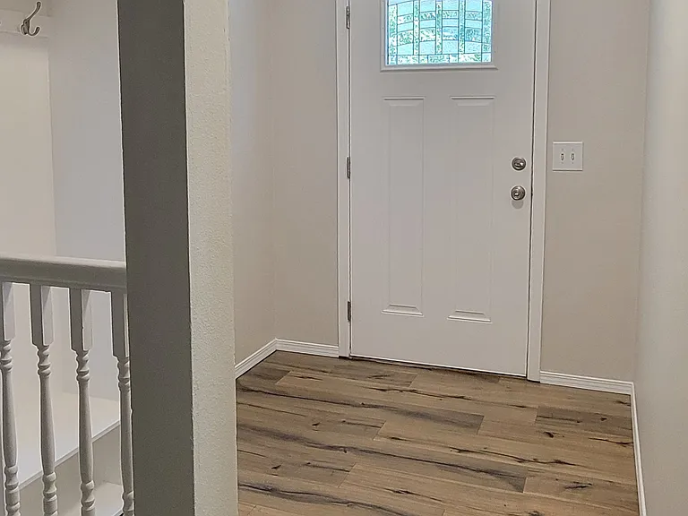 Front door, foyer, and coat rack on the left.