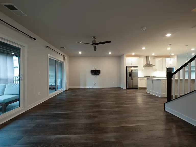 Living room comes with high end Sanus full motion TV mount with in-wall HDMI cable management and ethernet outlet. Overhead lighting and ceiling fan are smart/WiFi enabled. Two sliding doors to access large covered lanai balcony on either ends.