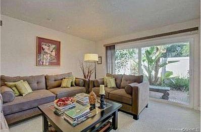 Formal living room with recessed lighting, neutral decor and ope