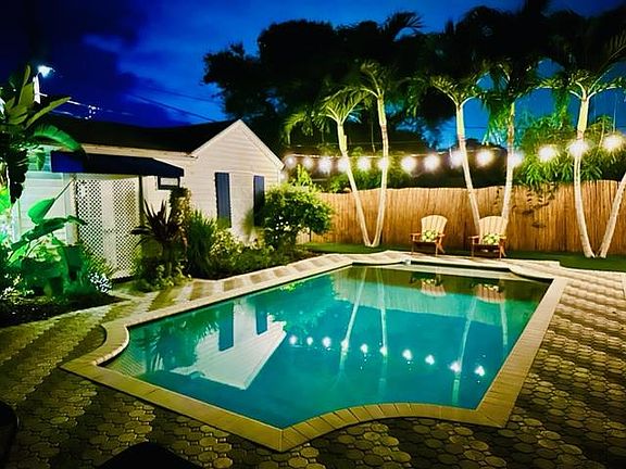 Pool and back yard by night.
