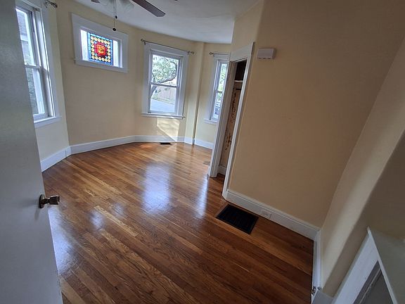 Bedroom #1: Ceiling fan, hardwood floors, stained glass window in addition to 3 regular windows. Has built-in shelves and drawers in addition to closet.