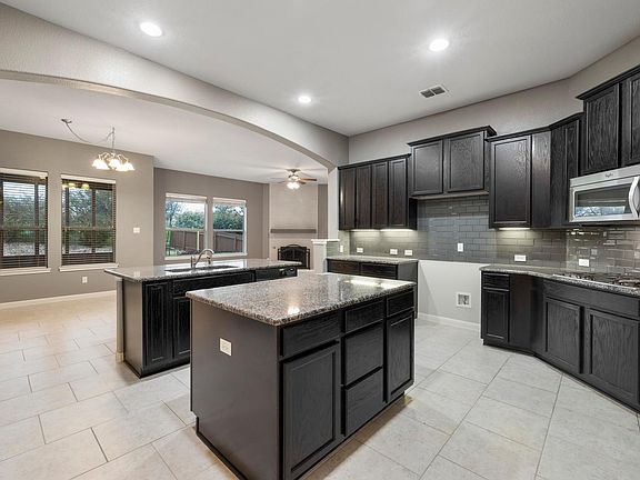 Large open concept kitchen, dinning room, living room. Lots of great storage and th edouble island makes meal prep easy!