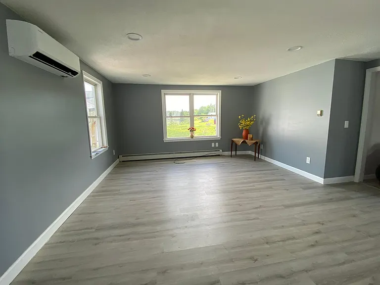 Living room with new flooring, paint and heat pump