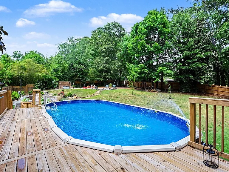Above ground pool with 7 ft deep end and deck