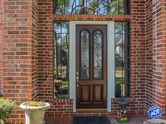 A beautiful brick covered entrance with leaded glass mahogany door and sidelights to welcome you in.