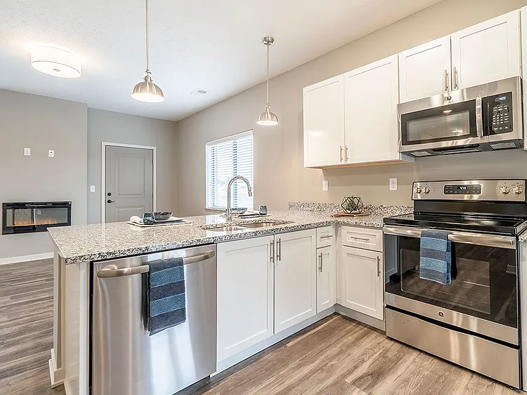 Our contemporary design scheme features white cabinetry and light granite countertops