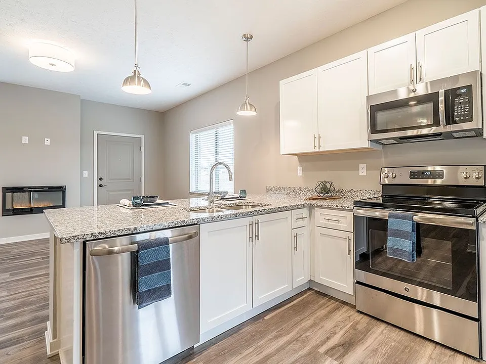 Our contemporary design scheme features white cabinetry and light granite countertops