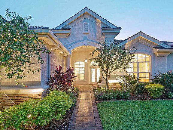A large covered foyer greets you while elegant custom lead glass doors give you entrance into this stunning estate.