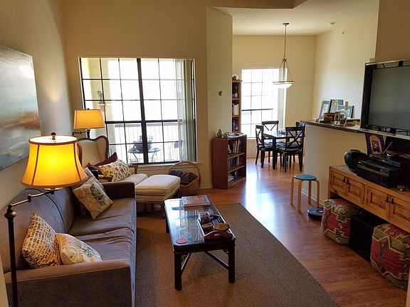 living room looking toward balcony patio, dining area, and k