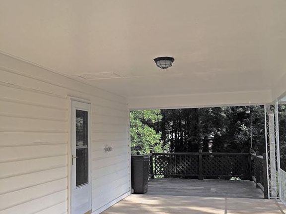 Hidden Cir carport. Deck extends off the back. Kitchen entrance is steps away for ease of unloading groceries.