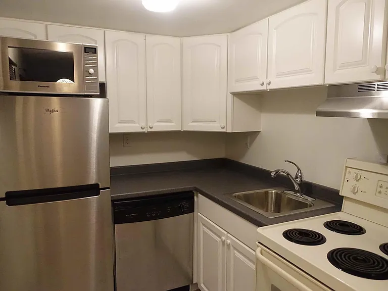 Kitchen includes refrigerator, microwave, dishwasher, stainless steel sink with disposal, electric oven/range with stainless steel hood, lots of cabinet space!