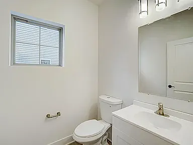 powder room on great room level with privacy window and adjacent to large coat closet