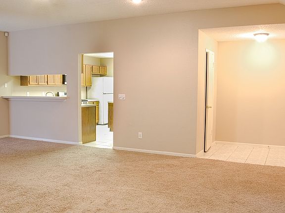 living room looking at front door and kitchen