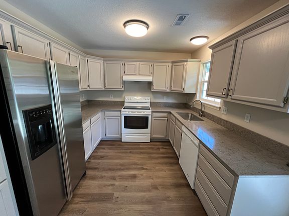 Kitchen with windows looking out to the back yard