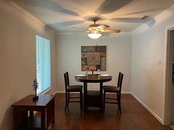 Lovely hardwood floor dining area with ceiling fan.