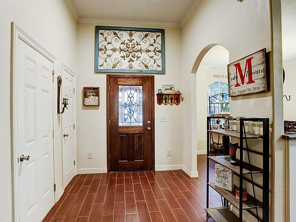 The front entry is open and leads visitors to the dining room and kitchen. A convenient coat closet is located at the entrance.