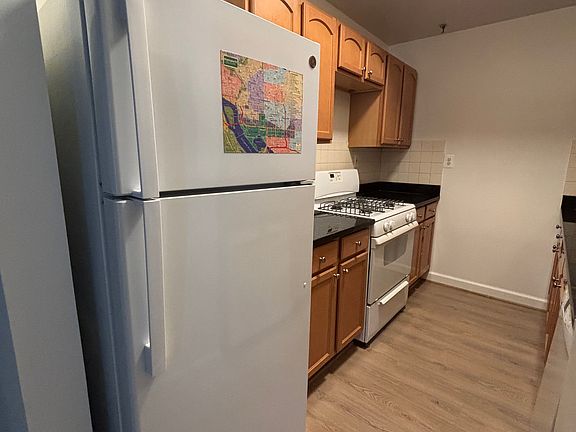 Kitchen with refrigerator, stove, microwave, sink with garbage disposal, dishwasher, and cabinetry