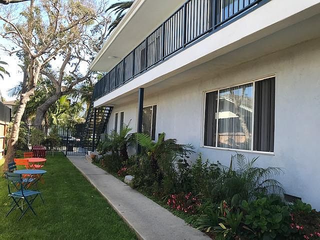 Midcentury building with landscaped courtyard maintained by weekly gardener. Cafe tables and chairs.