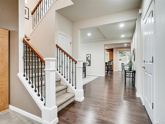 Flex space upstairs is outfitted with glass cooktop stove with safety timer, refrigerator and stainless steel sink.