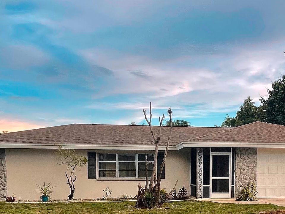 front view of the home with visible fence, 2 car garage